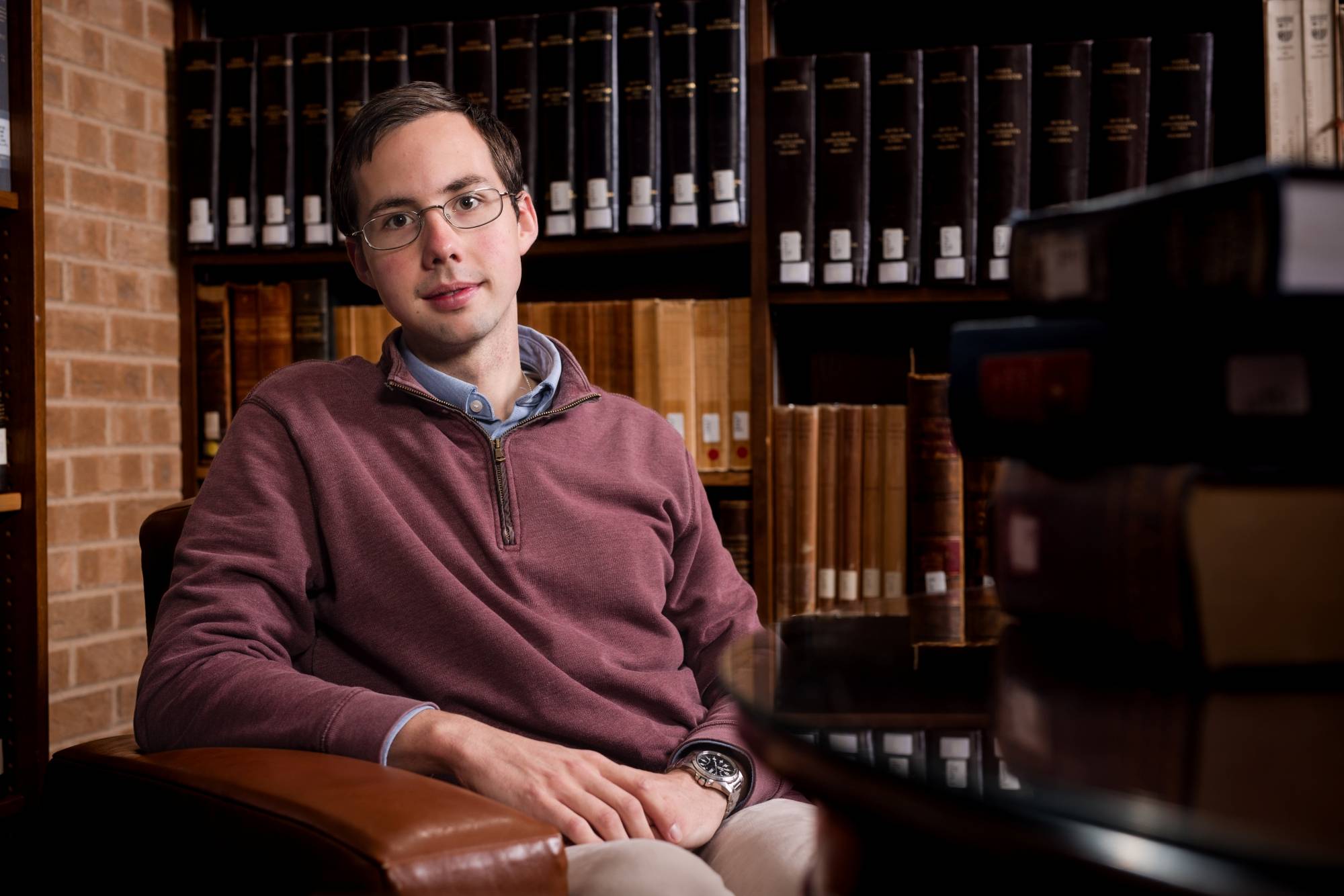 Owen Embree seated in the Cowan-Blakley Memorial Library in front of the Index Thomisticus